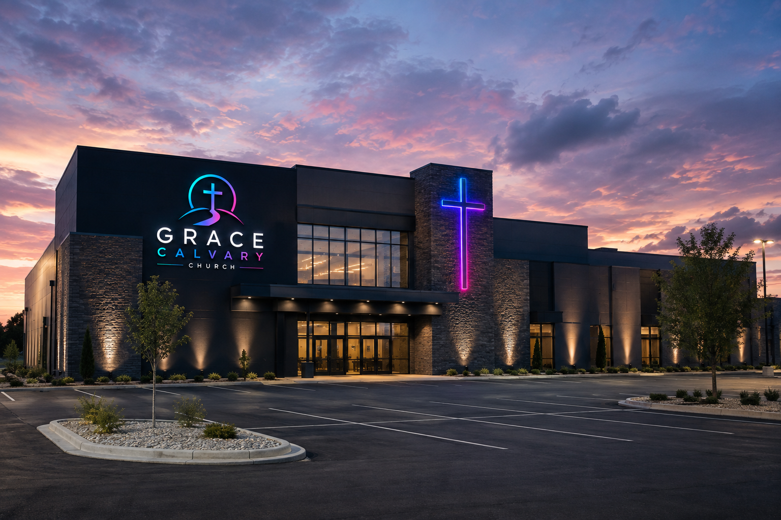 Grace Calvary Church building at dusk with a glowing neon cross